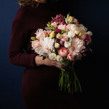 bouquet of pink flowers created with cafe au lait dahlias pink roses white tulips mauve hydranges and lisianthus and queen ann lace